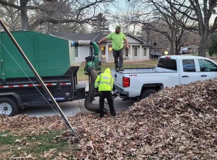 The Green Dynamics crew loading leaves into a truck during a fall clean-up