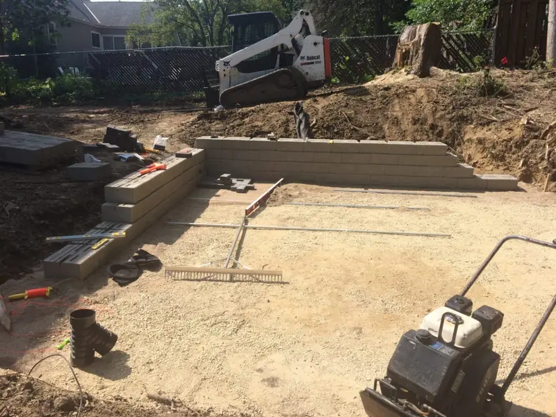 A backyard patio, fire pit and terracing project mid-build